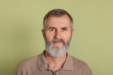 Photo of Portrait of senior man on green background