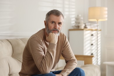 Photo of Portrait of handsome senior man at home