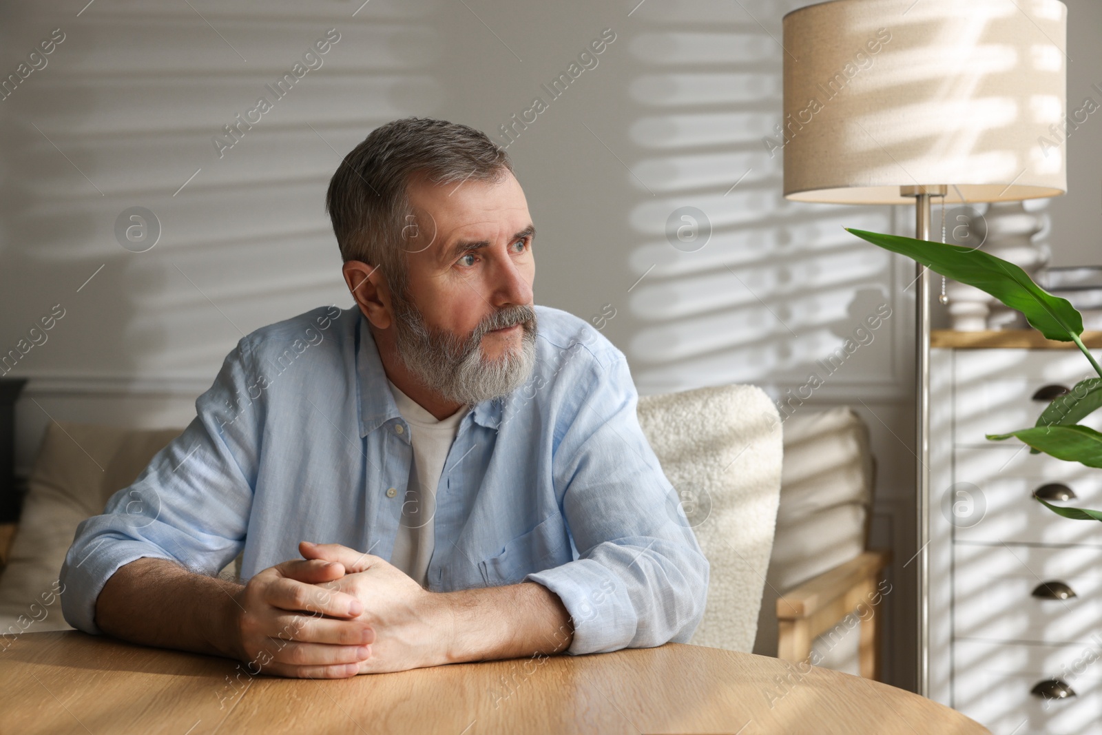 Photo of Portrait of handsome senior man at home