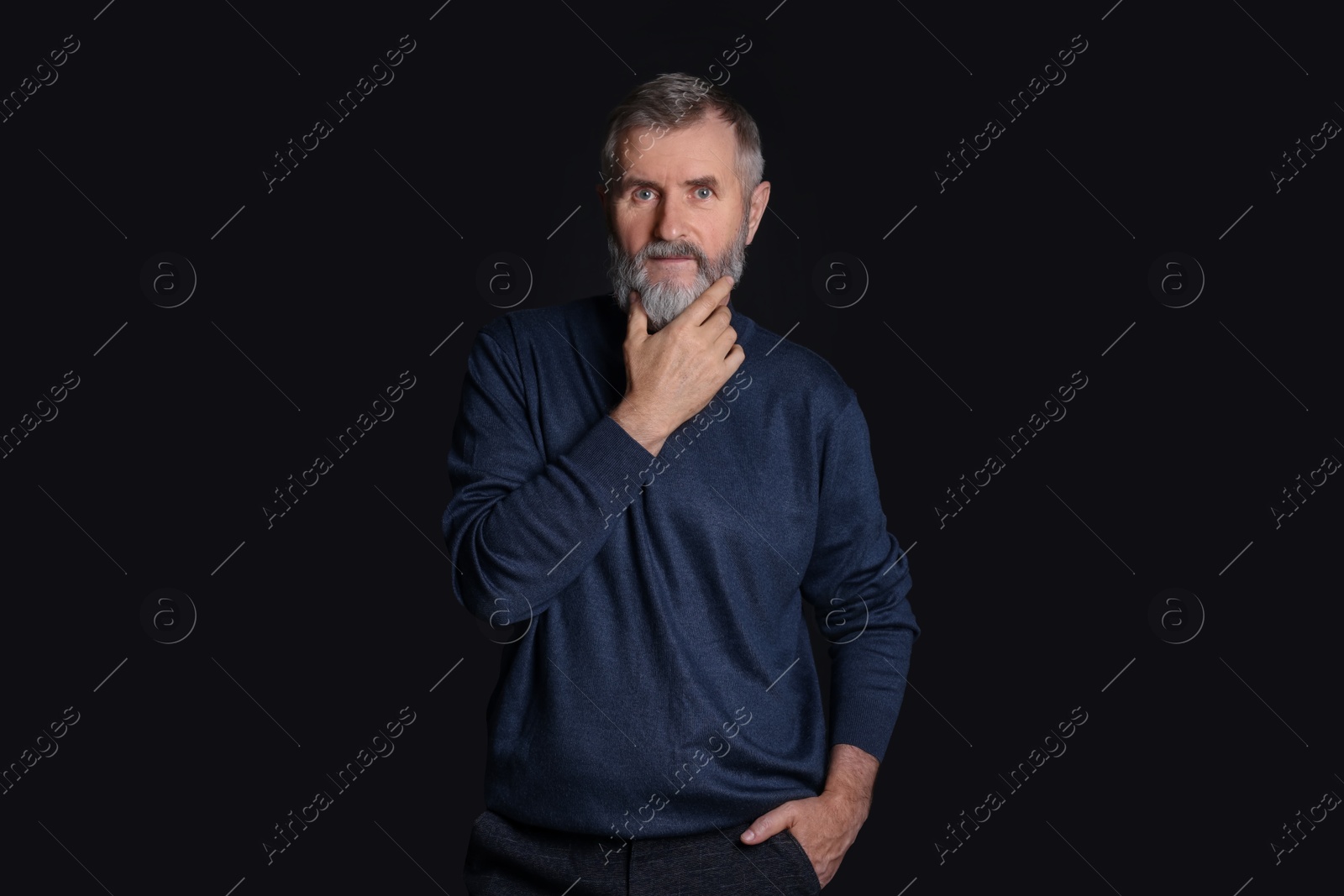 Photo of Portrait of senior man on black background