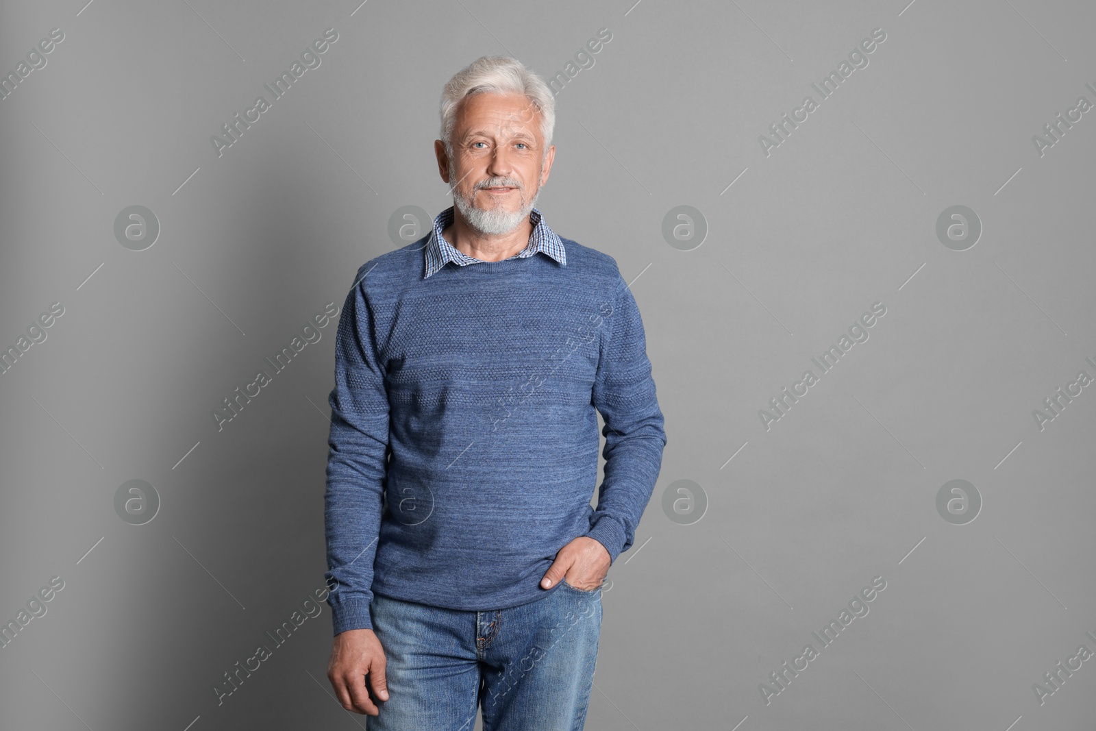 Photo of Portrait of senior man on grey background