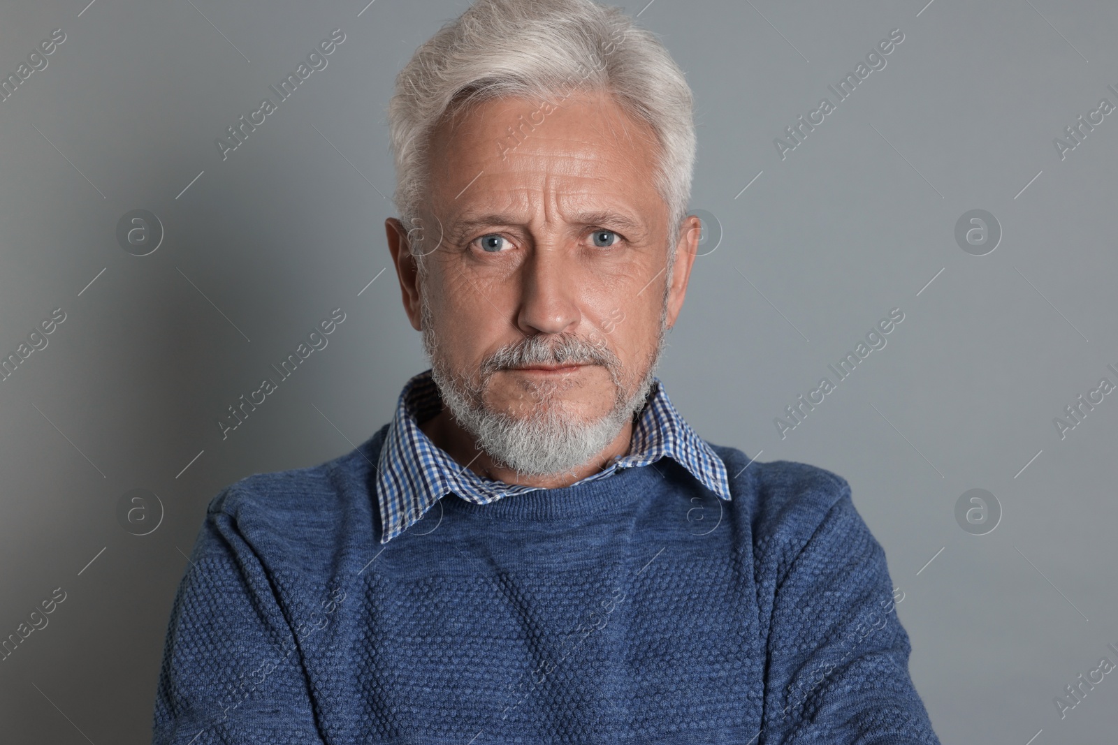 Photo of Portrait of senior man on grey background