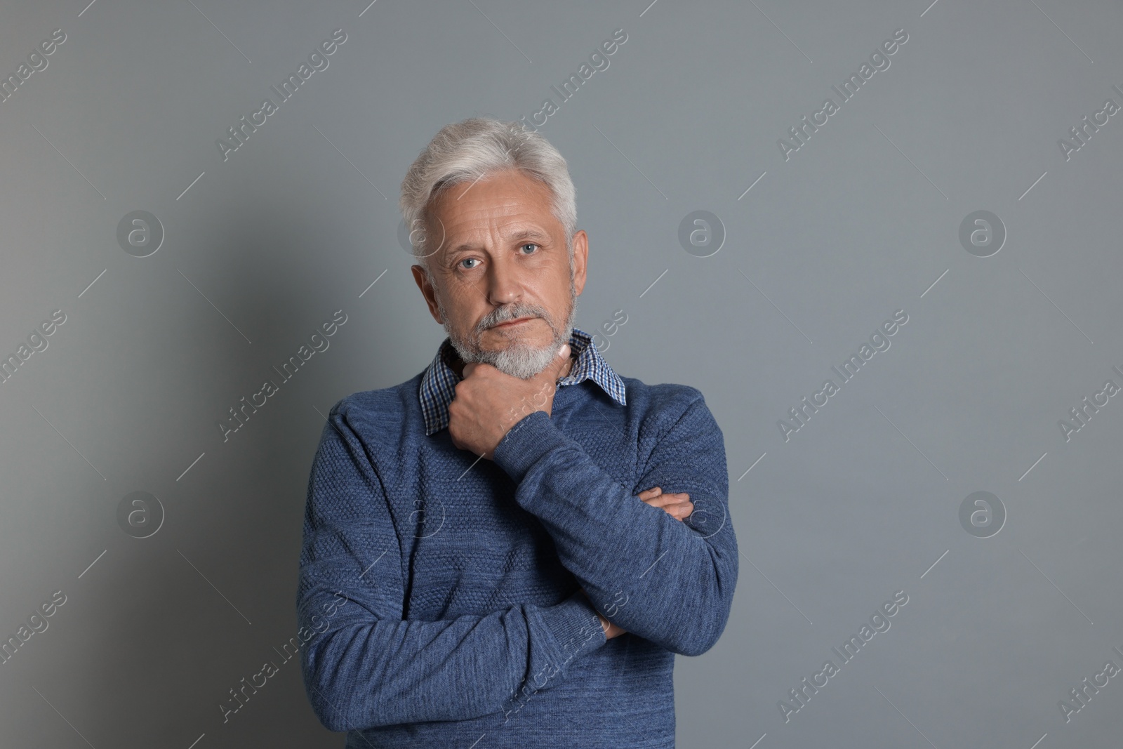 Photo of Portrait of senior man on grey background