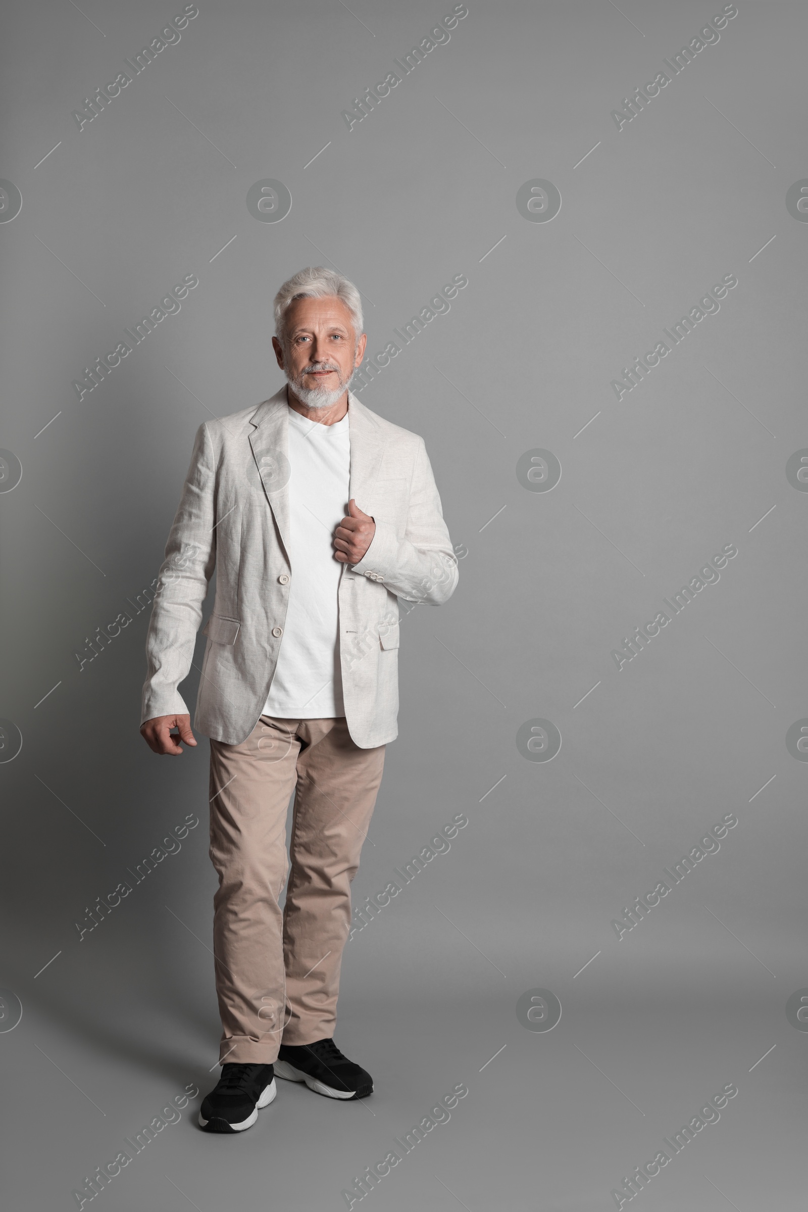 Photo of Full length portrait of senior man on grey background