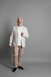 Photo of Full length portrait of senior man on grey background