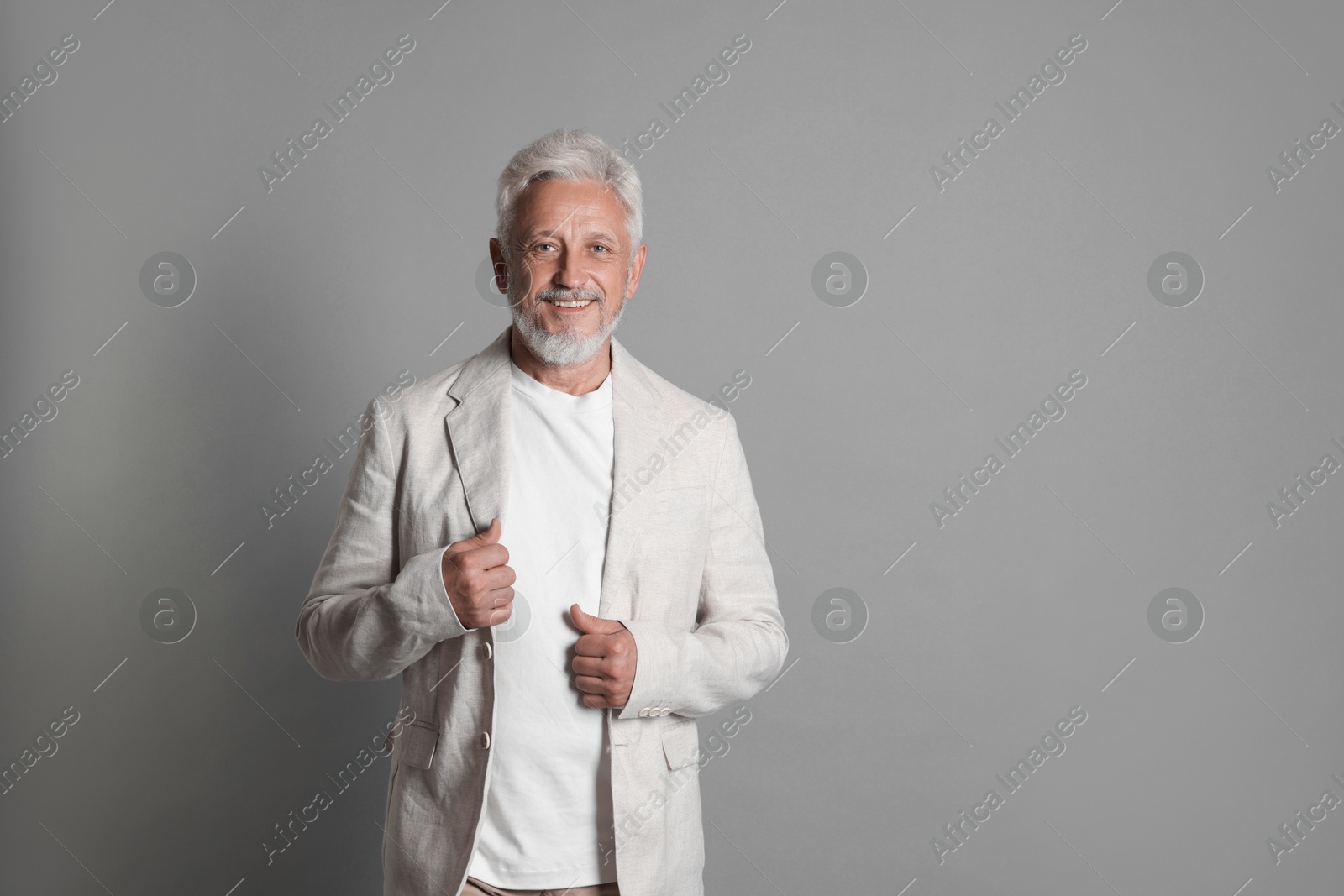 Photo of Portrait of senior man on grey background, space for text