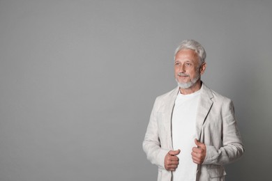 Photo of Portrait of senior man on grey background, space for text