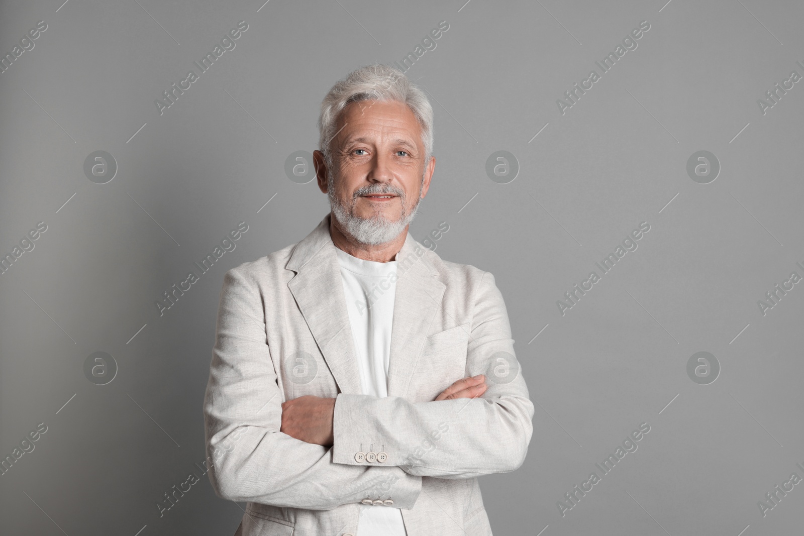 Photo of Portrait of senior man on grey background