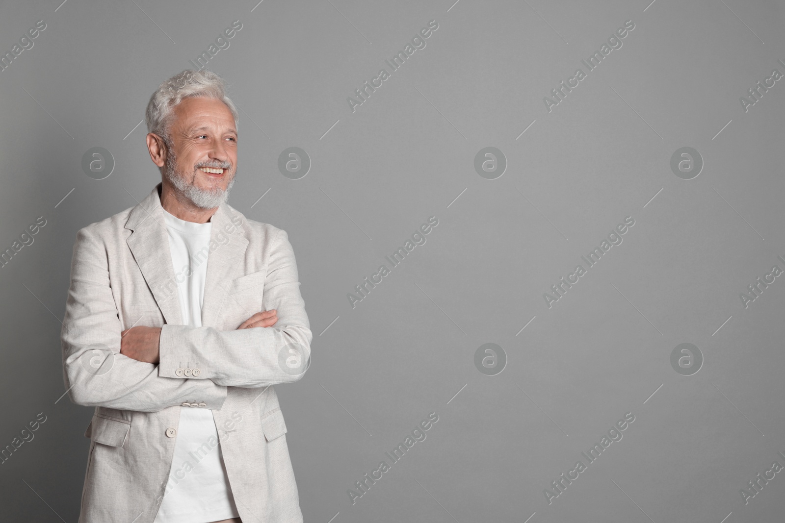 Photo of Portrait of senior man on grey background, space for text