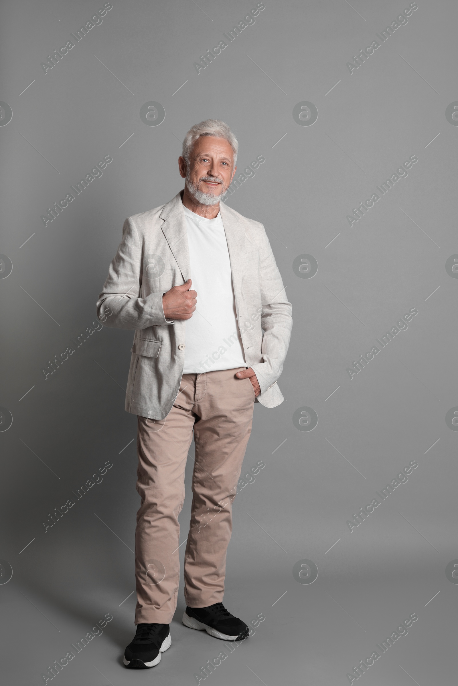 Photo of Full length portrait of senior man on grey background