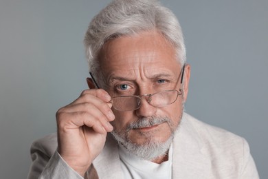 Photo of Portrait of senior man on grey background