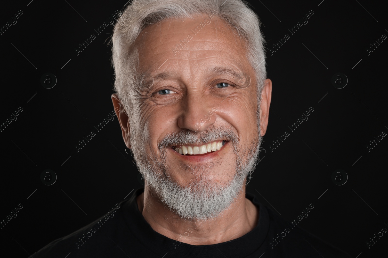 Photo of Portrait of senior man on black background