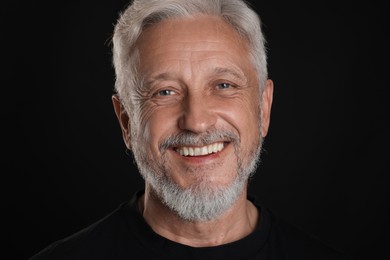 Photo of Portrait of senior man on black background