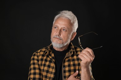 Photo of Portrait of senior man on black background