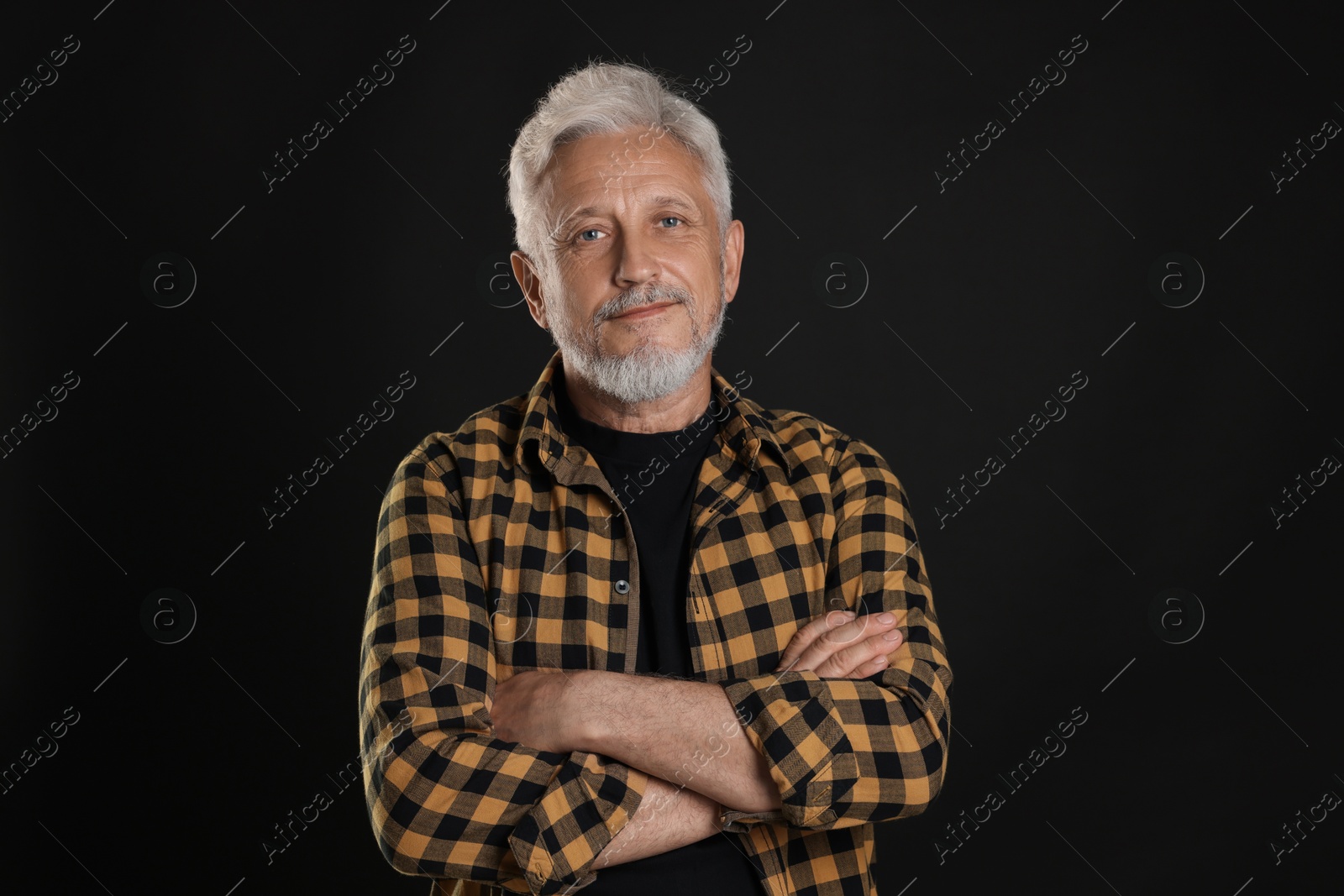 Photo of Portrait of senior man on black background