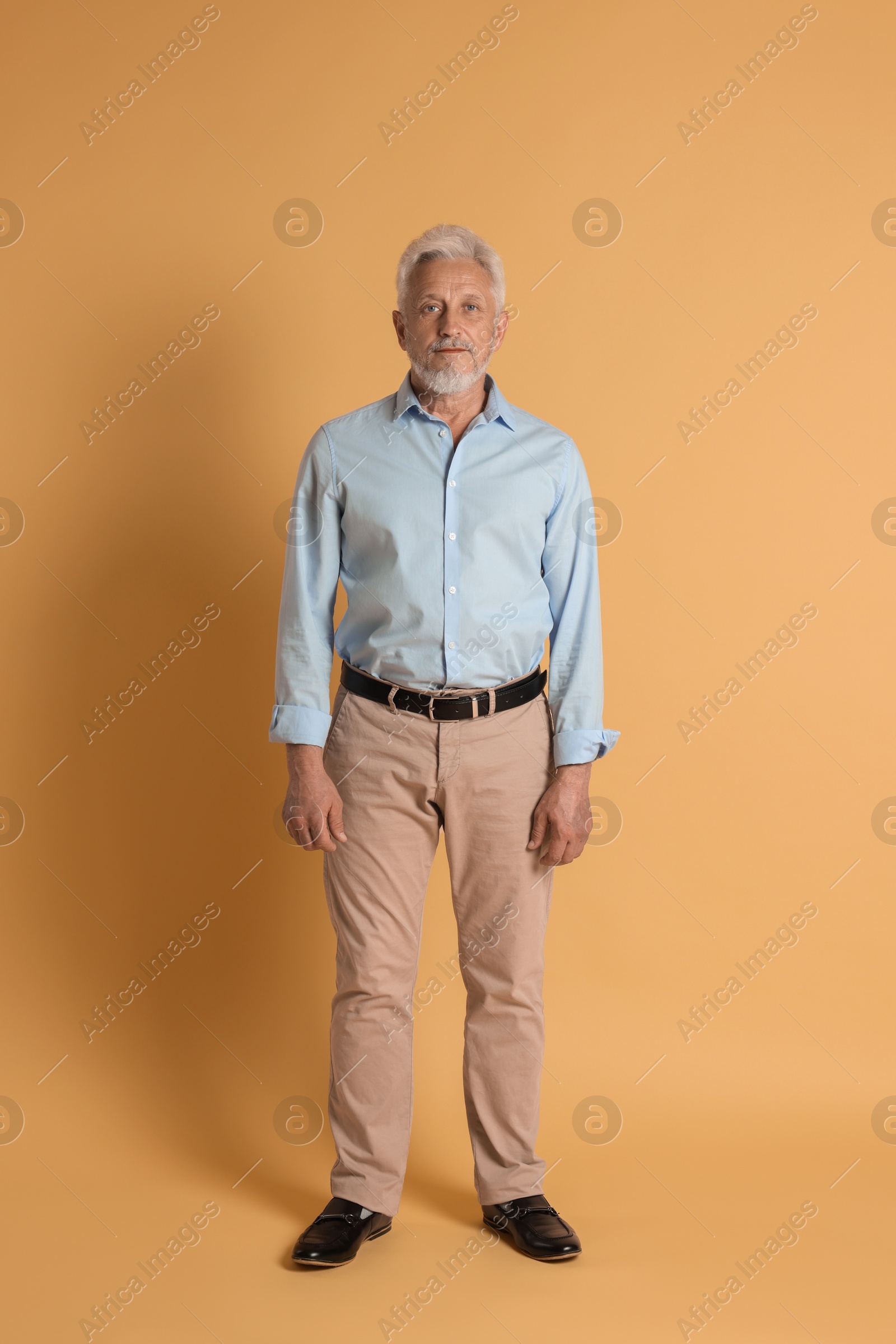 Photo of Full length portrait of senior man on beige background