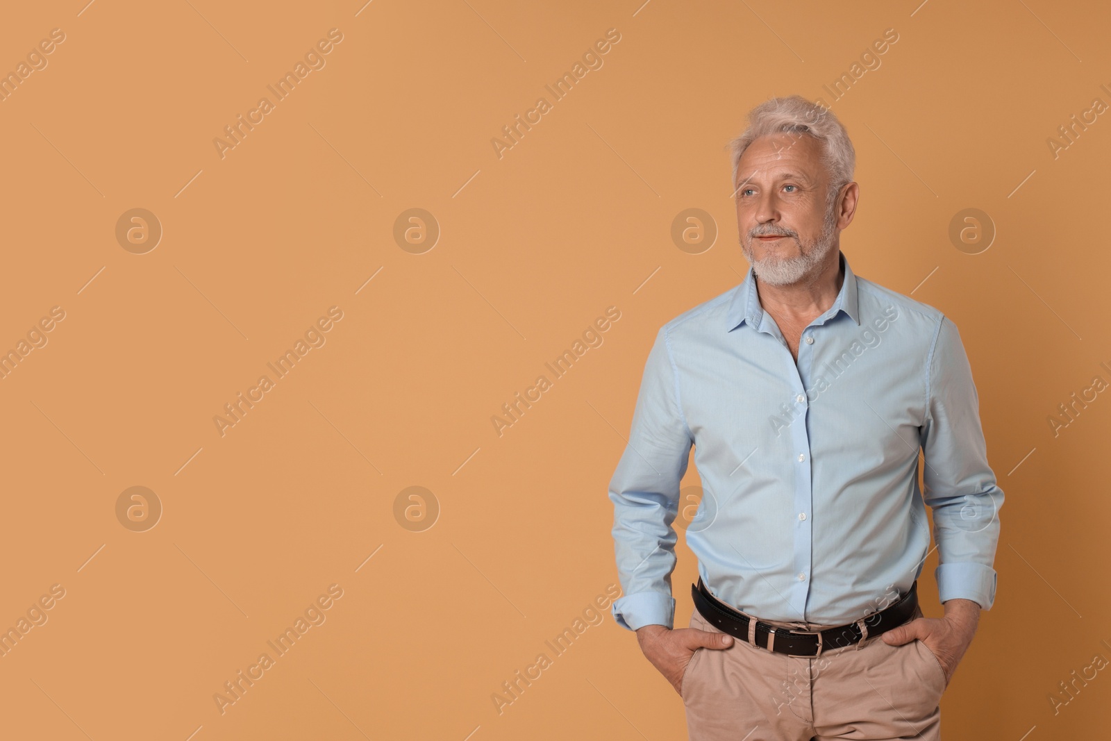 Photo of Portrait of senior man on beige background, space for text