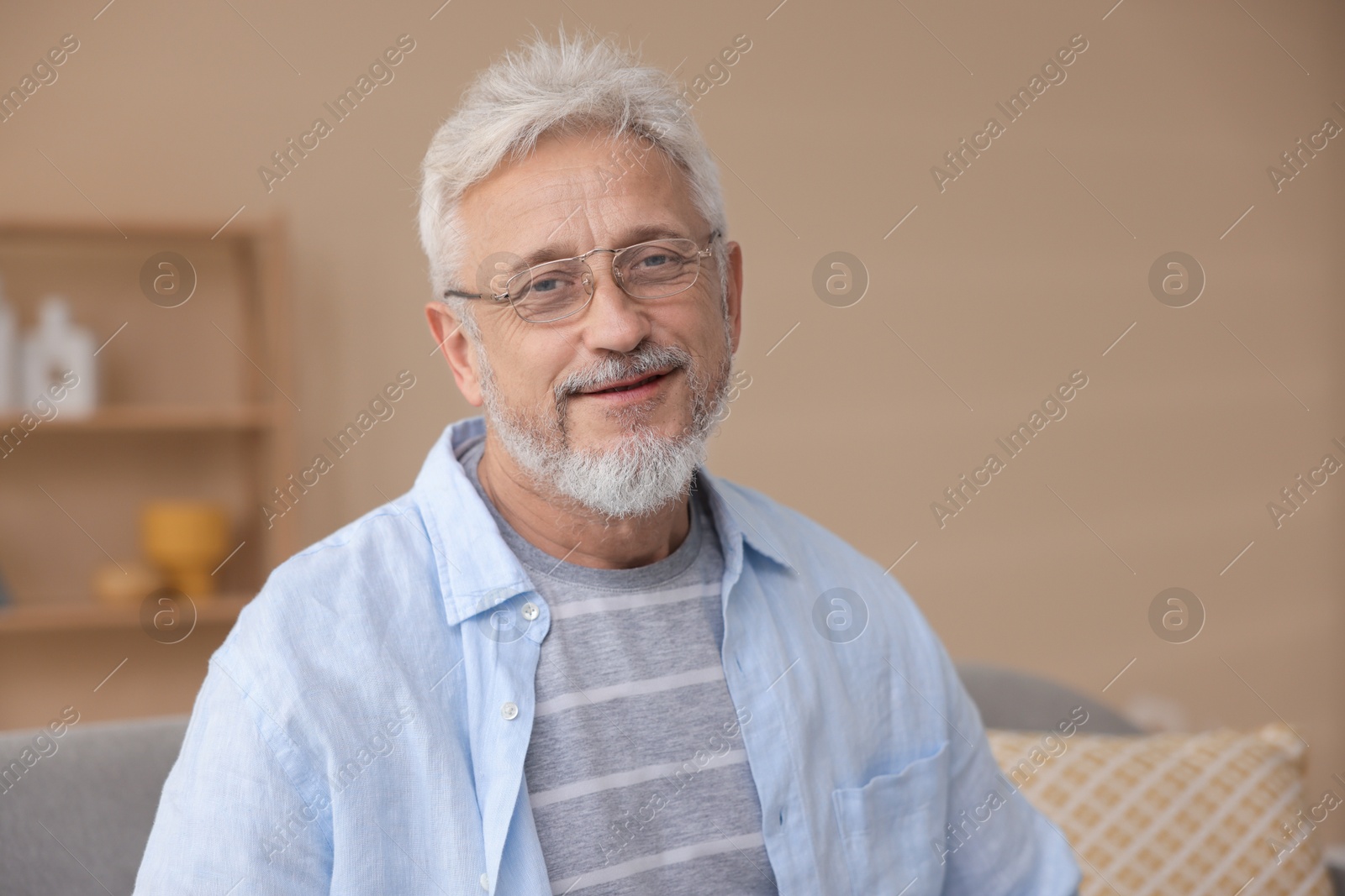 Photo of Portrait of senior man with glasses at home