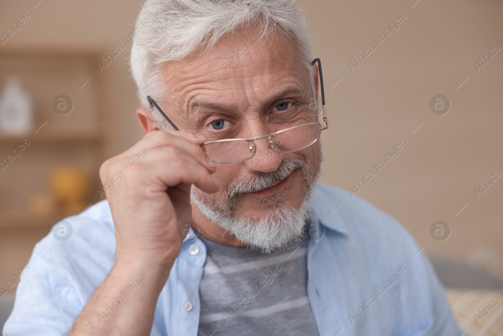 Photo of Portrait of senior man with glasses at home