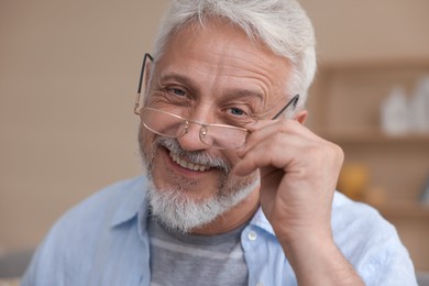 Photo of Portrait of senior man with glasses at home