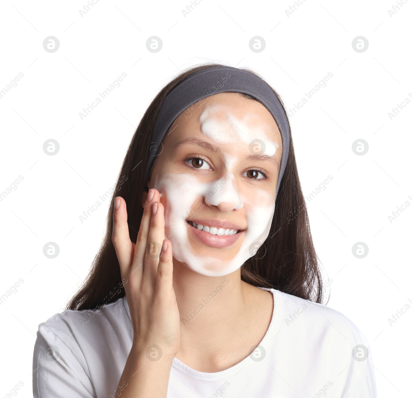 Photo of Teenage girl washing her face with cleanser on white background. Cosmetic product