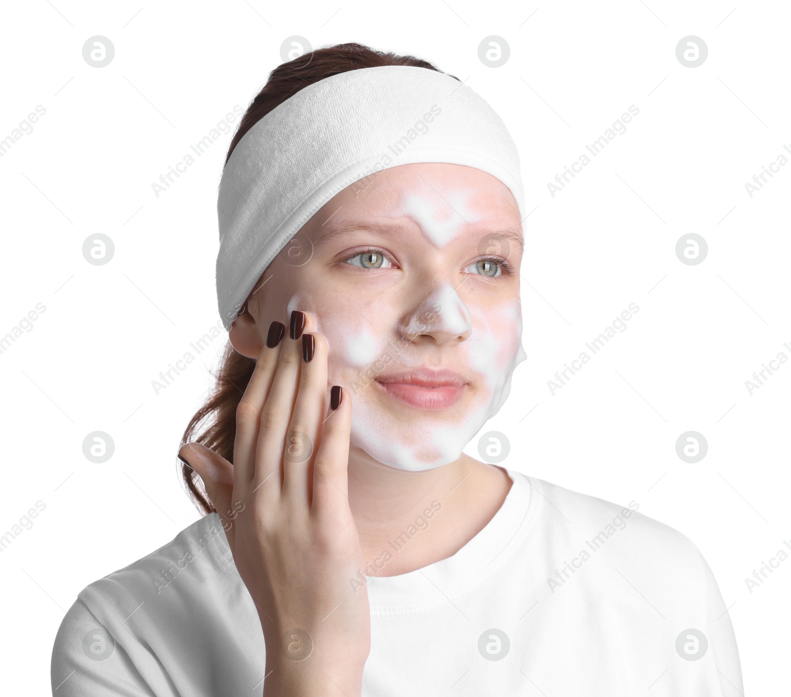 Photo of Teenage girl washing her face with cleanser on white background. Cosmetic product