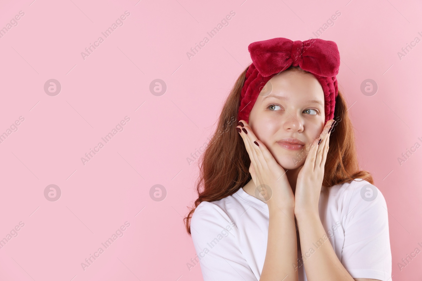 Photo of Portrait of teenage girl with headband on pink background, space for text