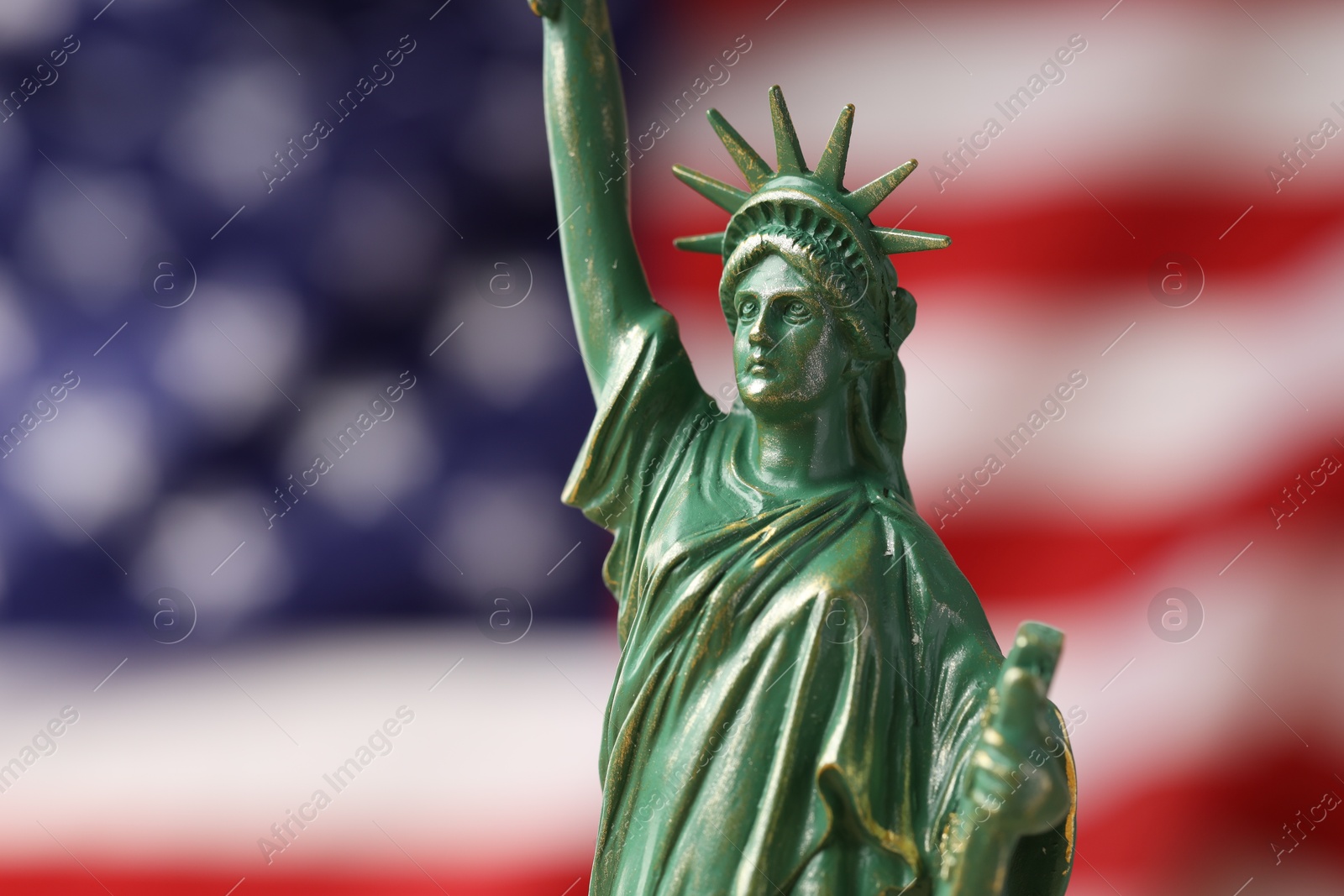 Photo of Statue of Liberty against flag of USA, closeup