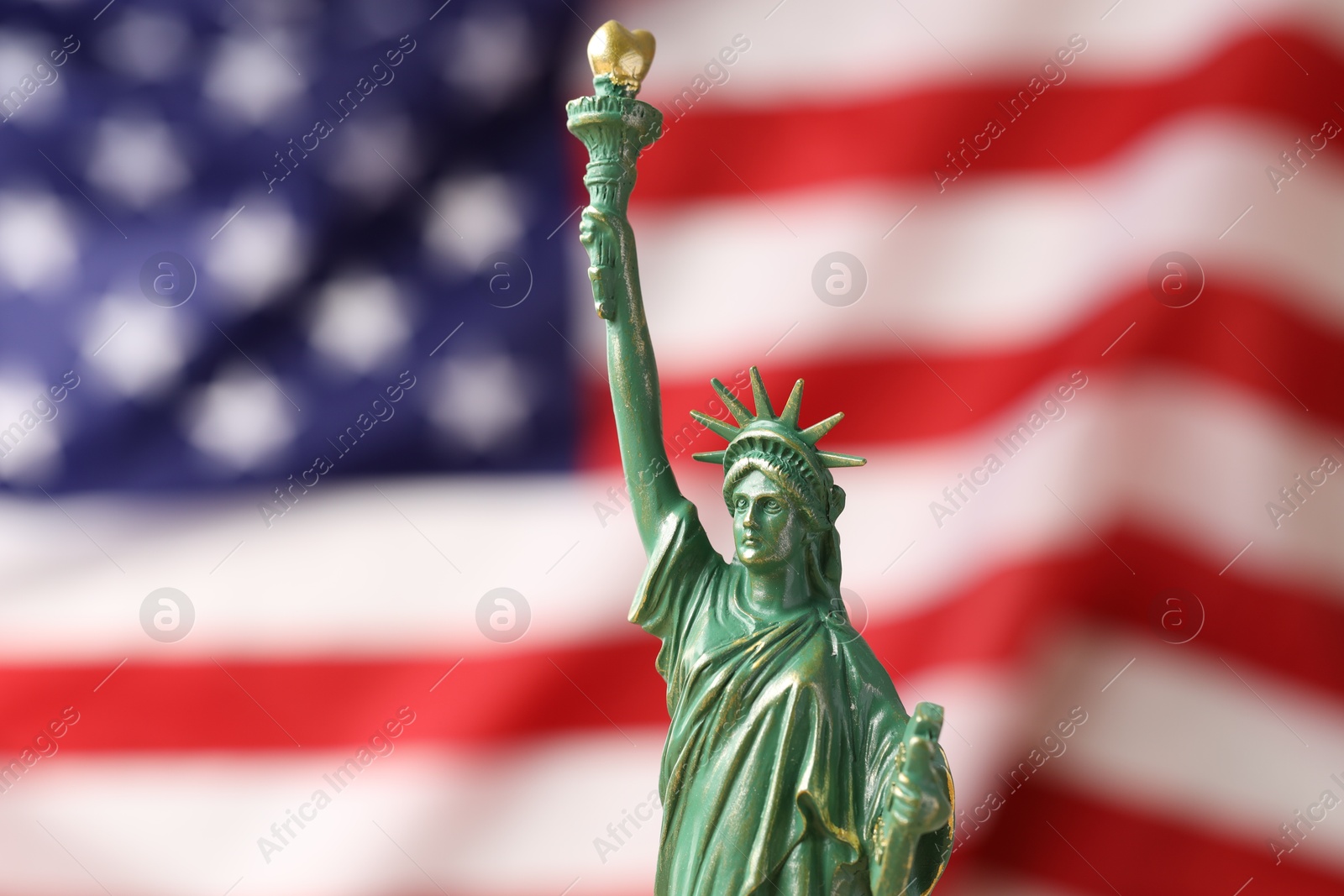 Photo of Statue of Liberty against flag of USA, closeup