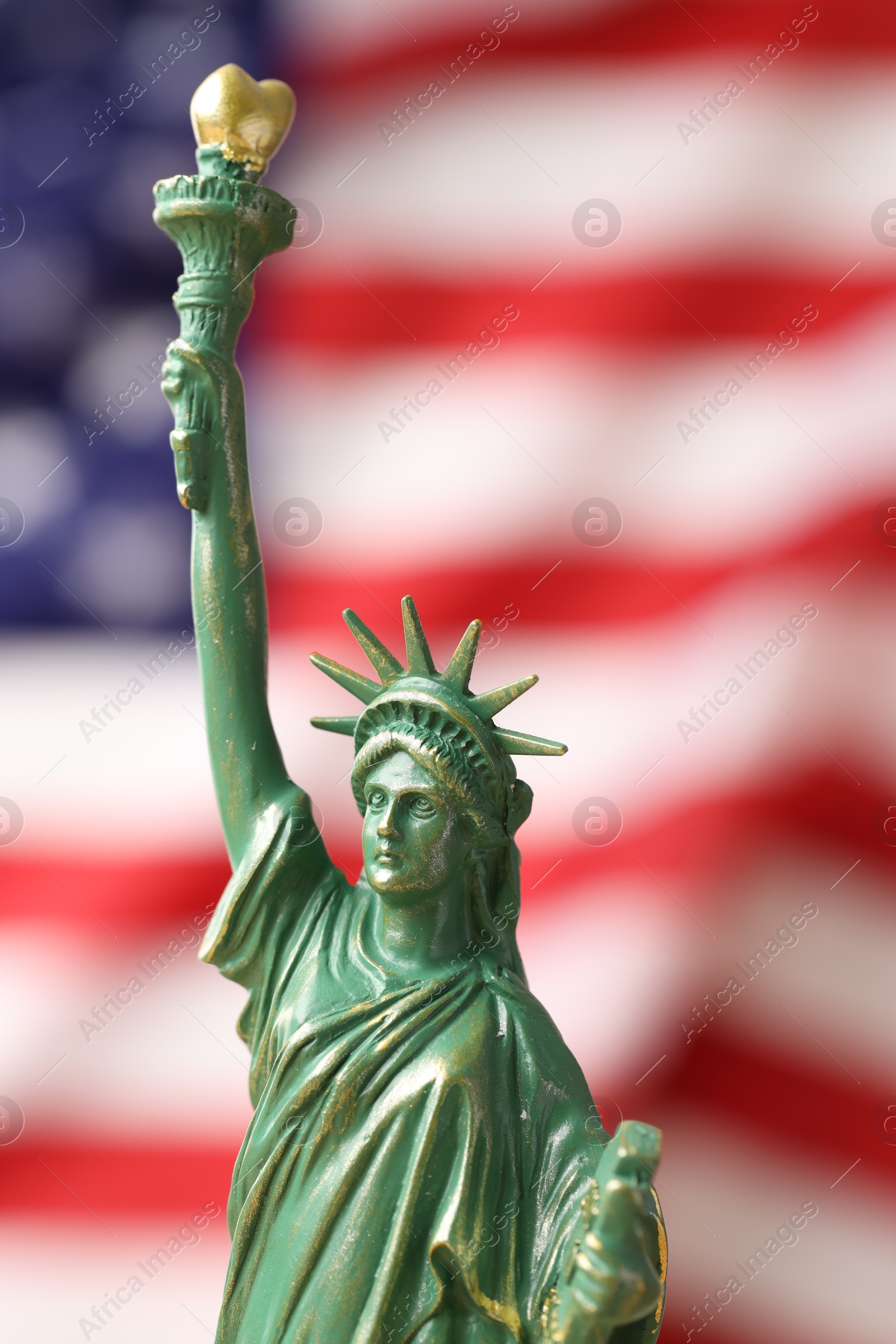 Photo of Statue of Liberty against flag of USA, closeup