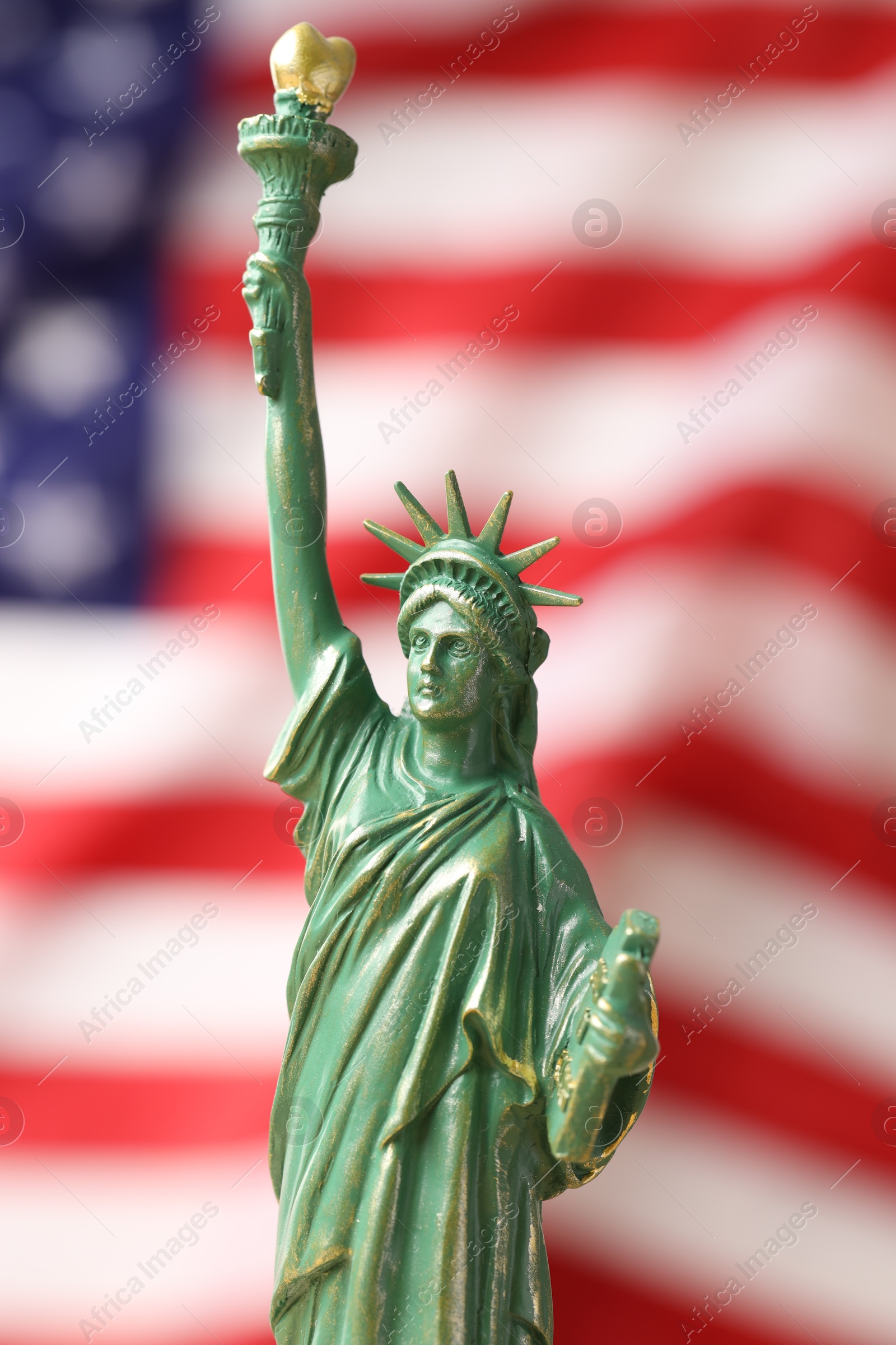 Photo of Statue of Liberty against flag of USA, closeup