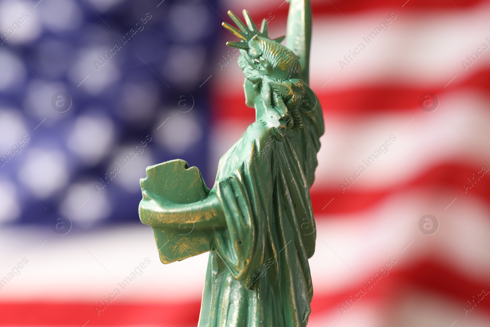 Photo of Statue of Liberty against flag of USA, closeup