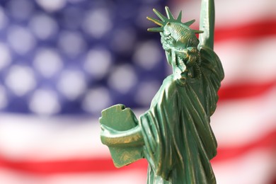 Photo of Statue of Liberty against flag of USA, closeup