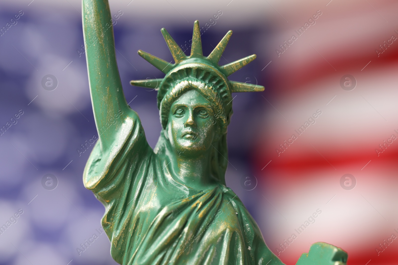 Photo of Statue of Liberty against flag of USA, closeup