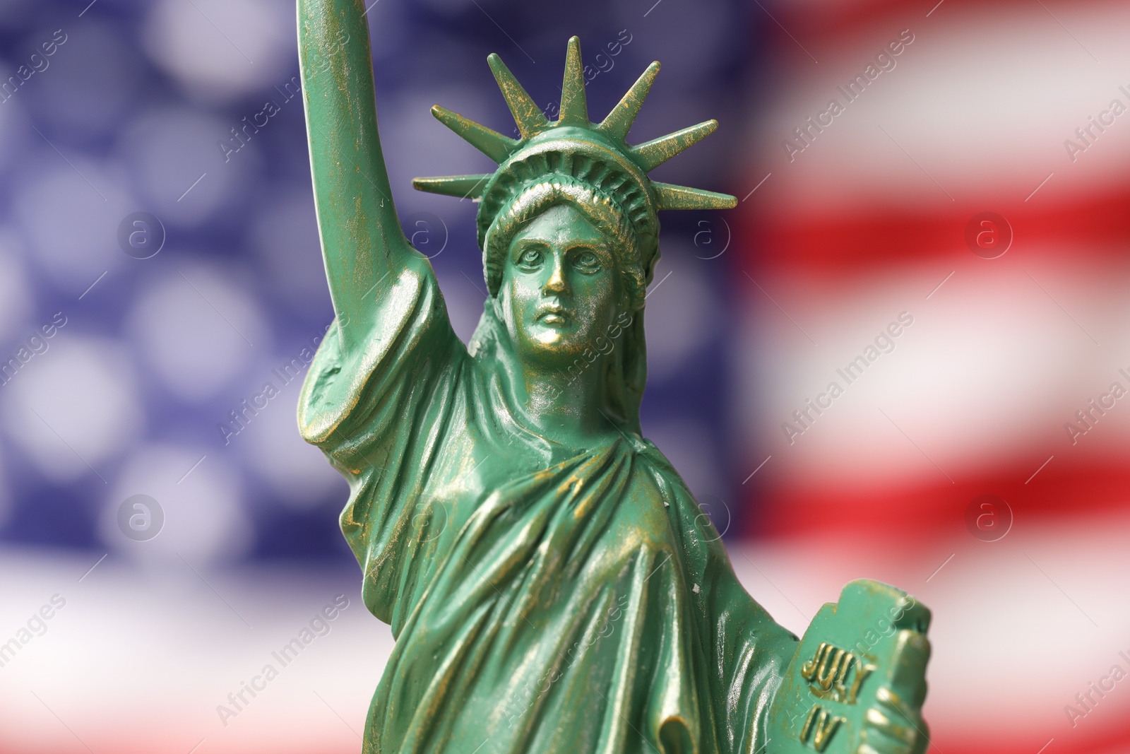 Photo of Statue of Liberty against flag of USA, closeup