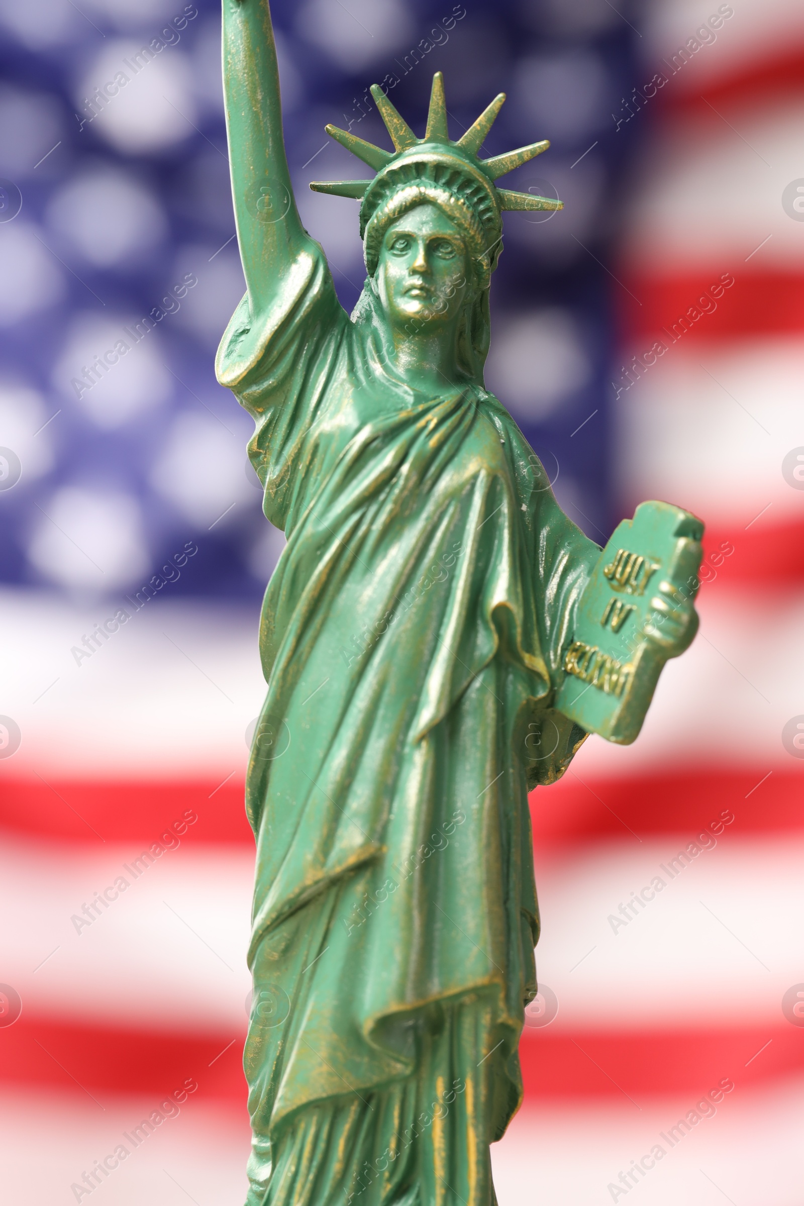 Photo of Statue of Liberty against flag of USA, closeup