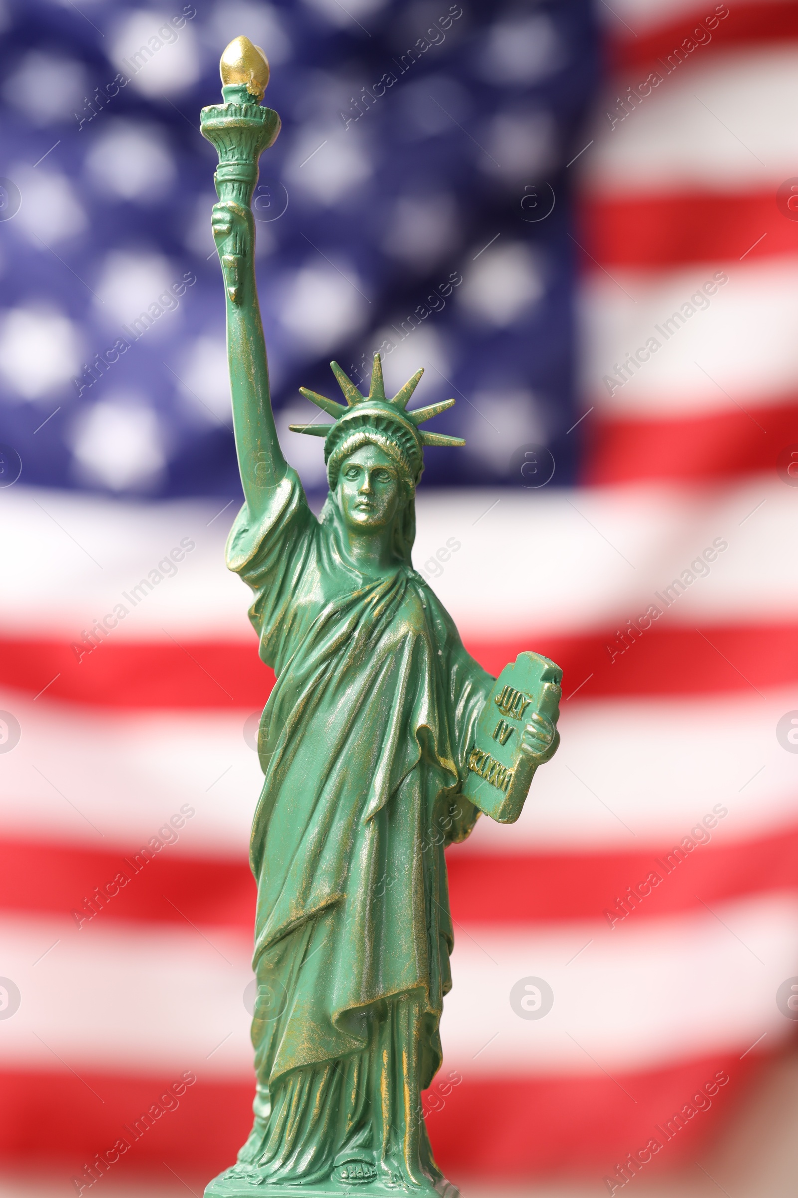 Photo of Statue of Liberty against flag of USA, closeup