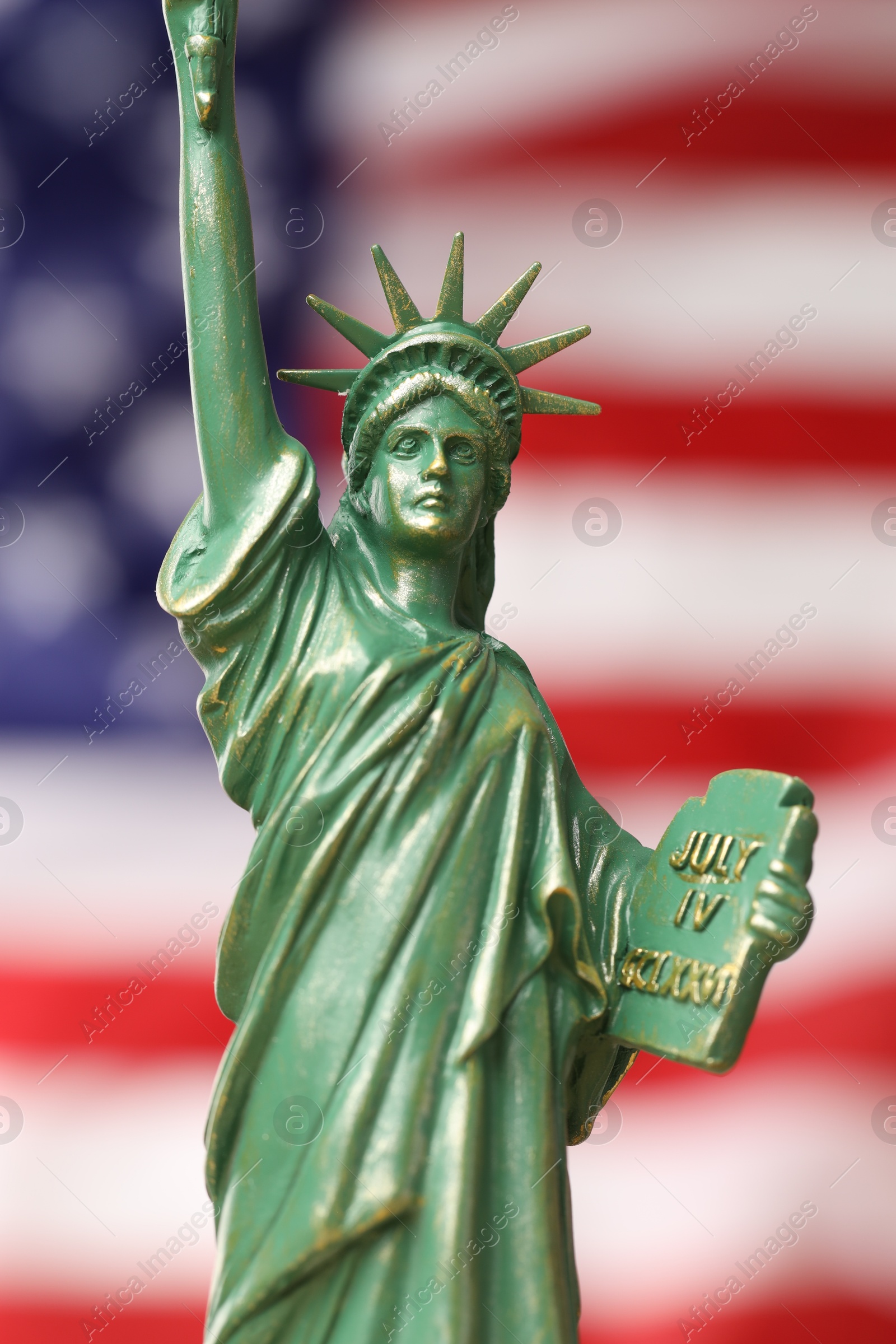 Photo of Statue of Liberty against flag of USA, closeup