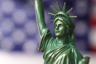 Photo of Statue of Liberty against flag of USA, closeup