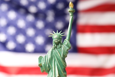 Photo of Statue of Liberty against flag of USA, closeup