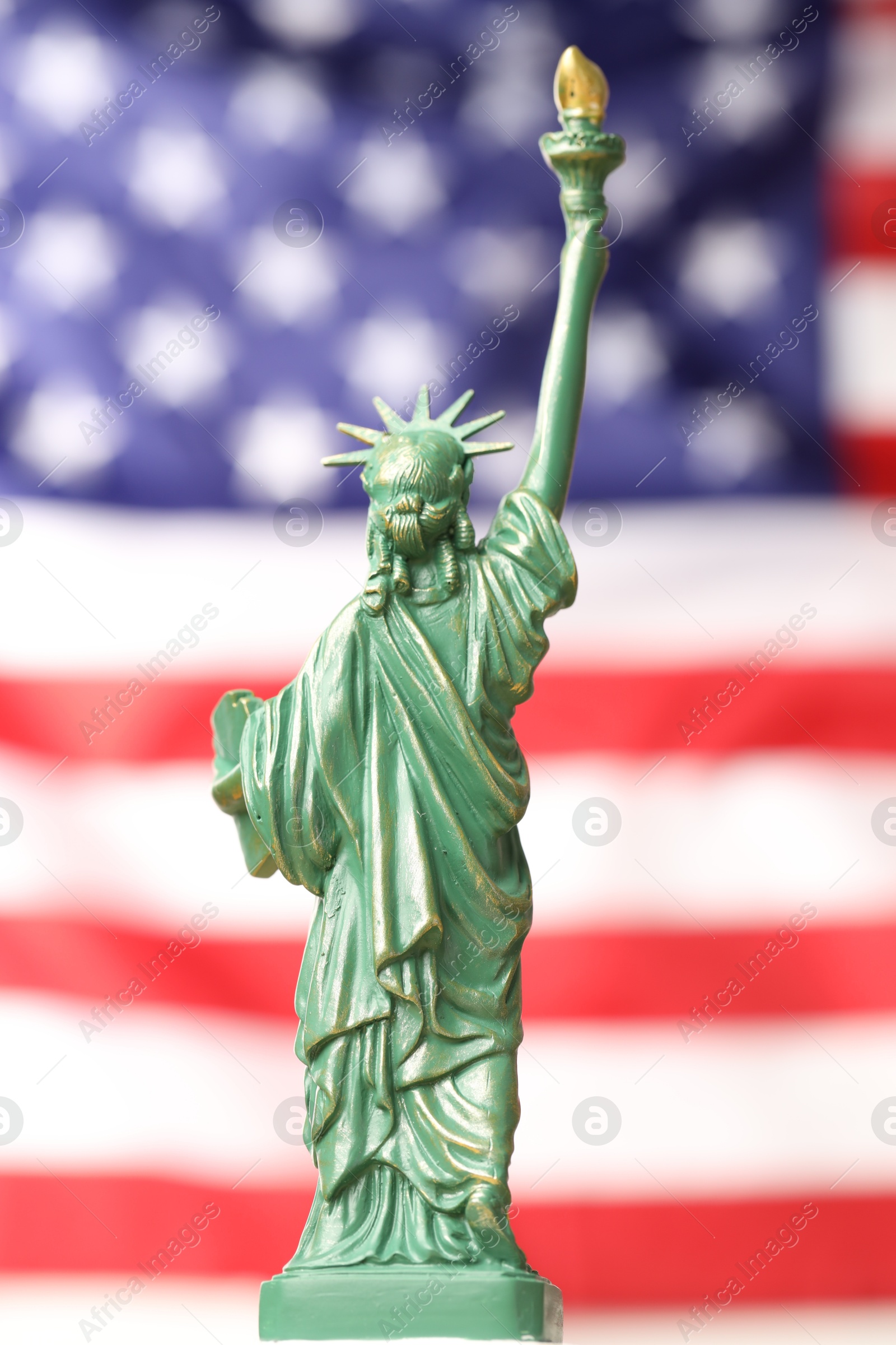 Photo of Statue of Liberty against flag of USA, closeup