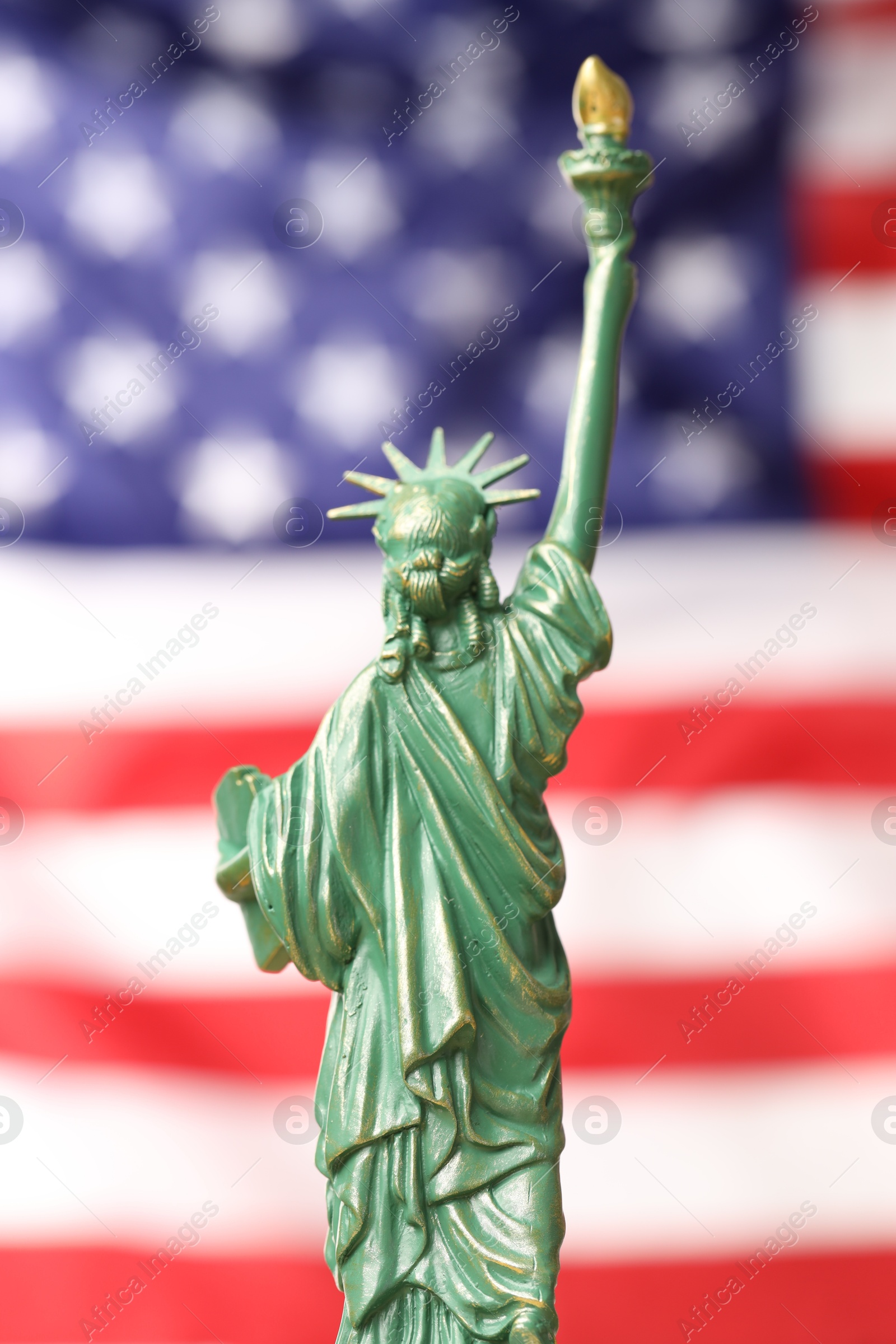 Photo of Statue of Liberty against flag of USA, closeup