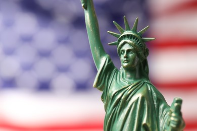 Photo of Statue of Liberty against flag of USA, closeup. Space for text