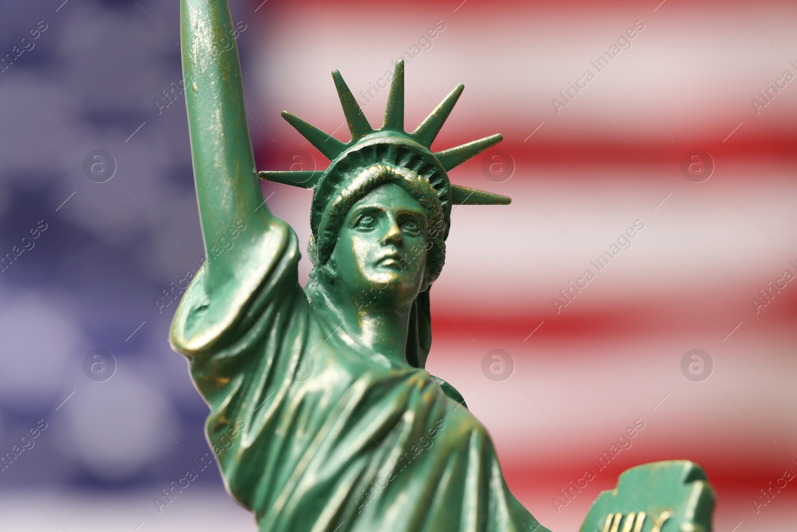 Photo of Statue of Liberty against flag of USA, closeup