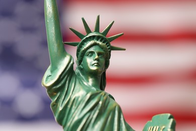 Photo of Statue of Liberty against flag of USA, closeup