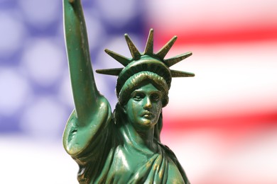 Photo of Statue of Liberty against flag of USA, closeup