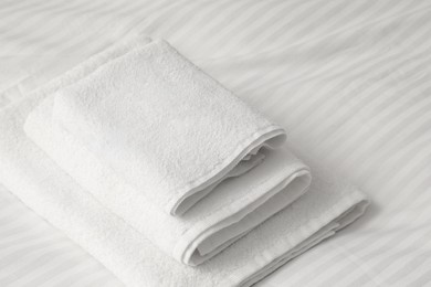 Photo of Stack of towels on clean linens indoors