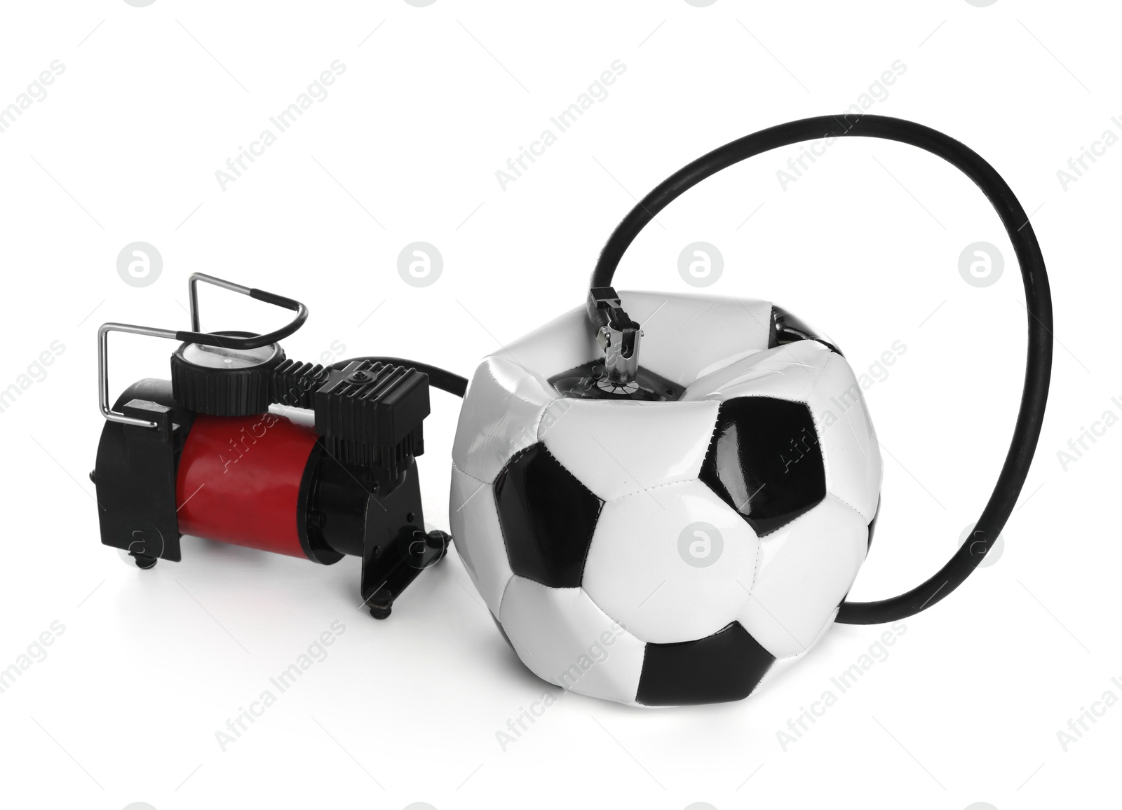 Photo of Deflated soccer ball and air compressor isolated on white