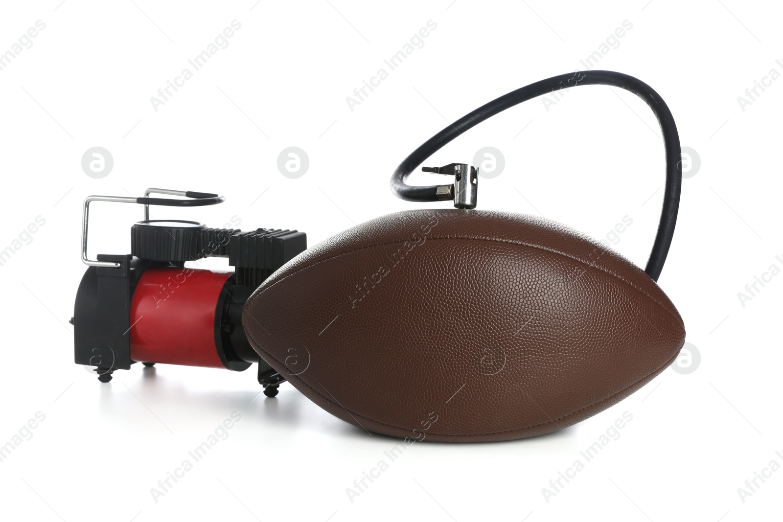 Photo of American football ball and air compressor isolated on white