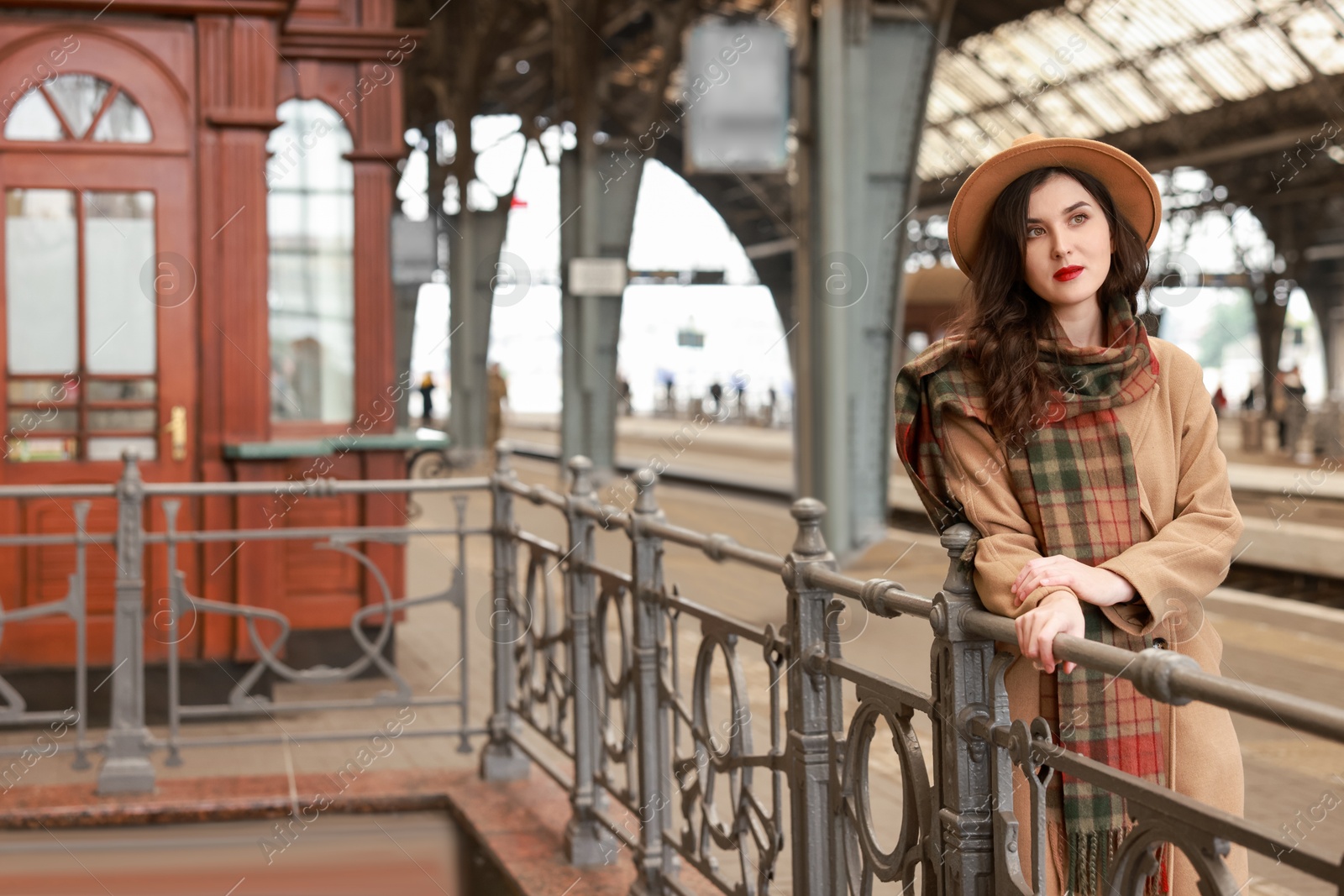 Photo of Beautiful woman in hat at railway station